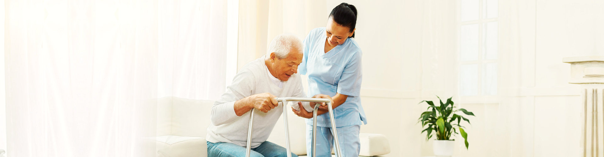 a caregiver assisting a senior man stand